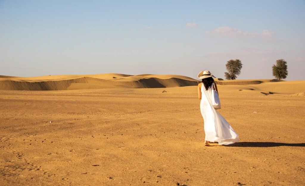 Woman wearing a white dress in the desert