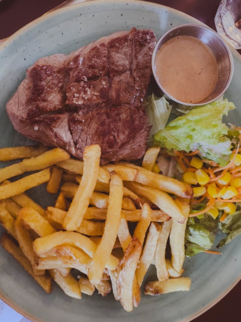 Our perfectly cooked steak frites served with peppercorn sauce at a sidewalk café in Montmartre