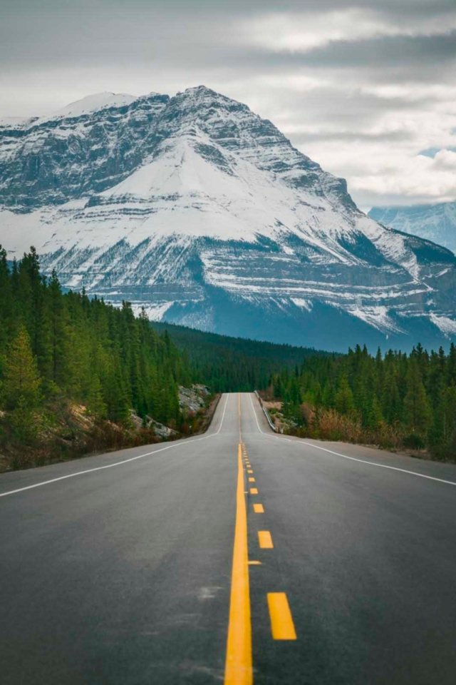 driving the open road with Hallett Peak in the background at Rocky Mountain National Park.