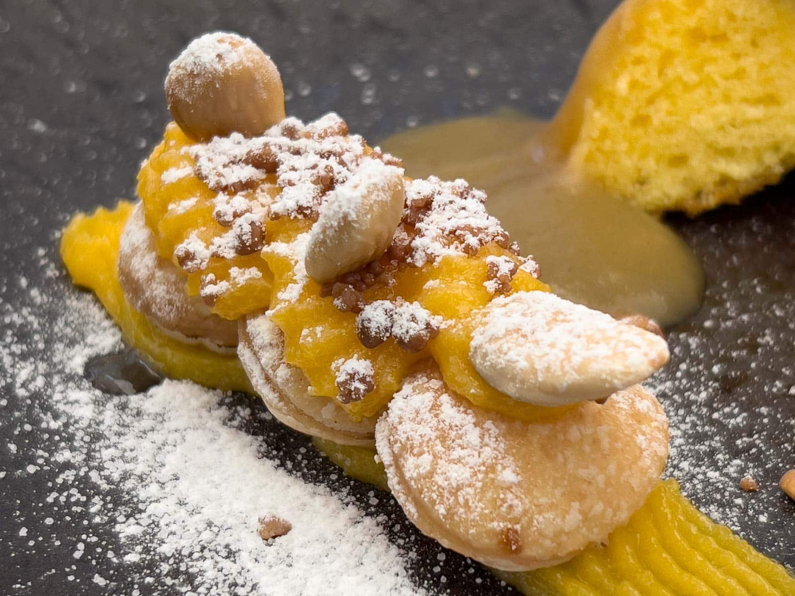 a sugar-coated Bola de Berlim doughnut with a creamy filling, at a Michelin star restaurant in Lisbon